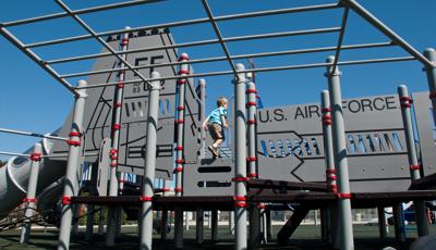Boy running on custom F-6 fighter jet play structure