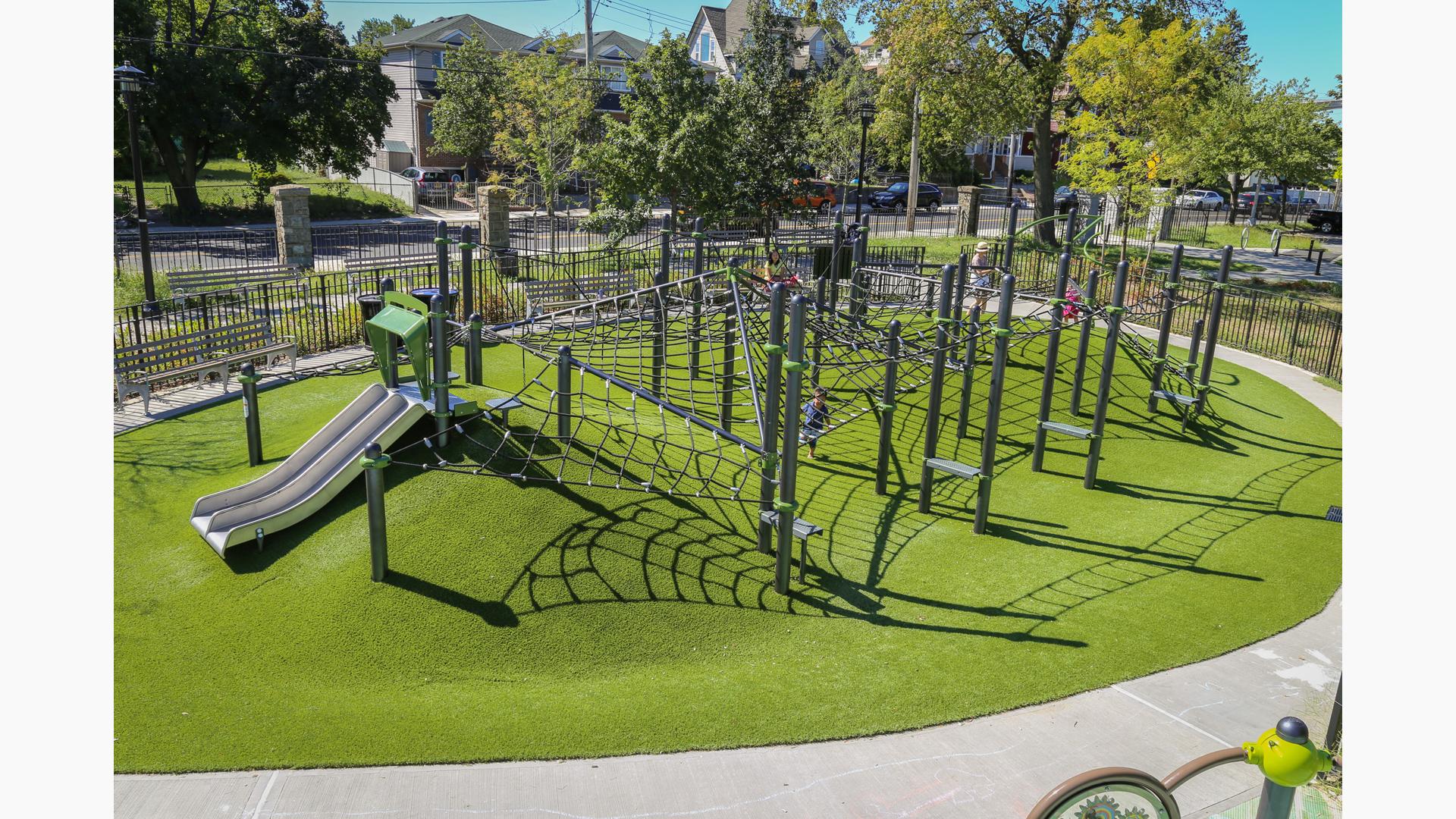 Custom net climber playground design on top of hilly topography.