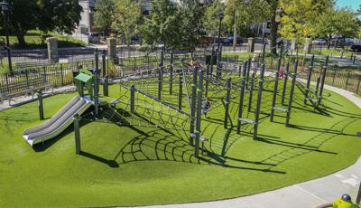 Custom net climber playground design on top of hilly topography.