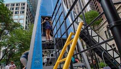 Girl standing on top step and looking inside custom play structure