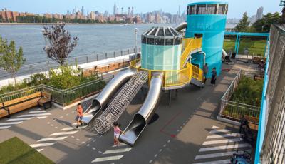 Historic Domino Sugar Factory in Brooklyn, NY turns into a community play space inspired by artist Mark Reigelman with bridge, beautiful colors and stainless steel slides.
