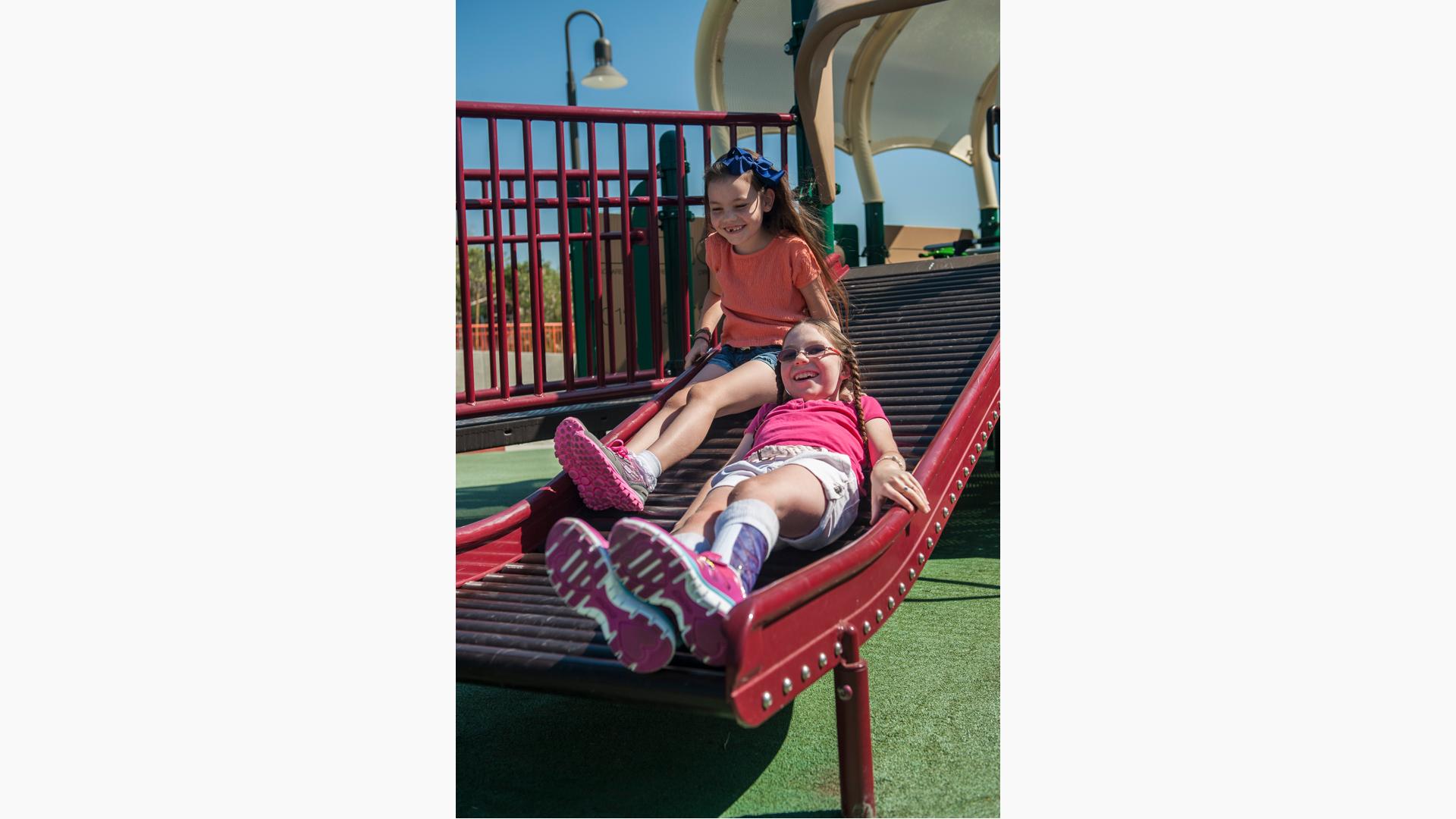 Two girls riding down Rollerslide