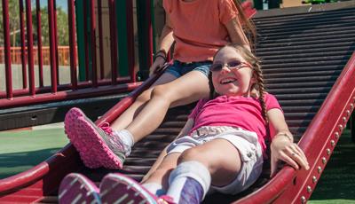 Two girls riding down Rollerslide