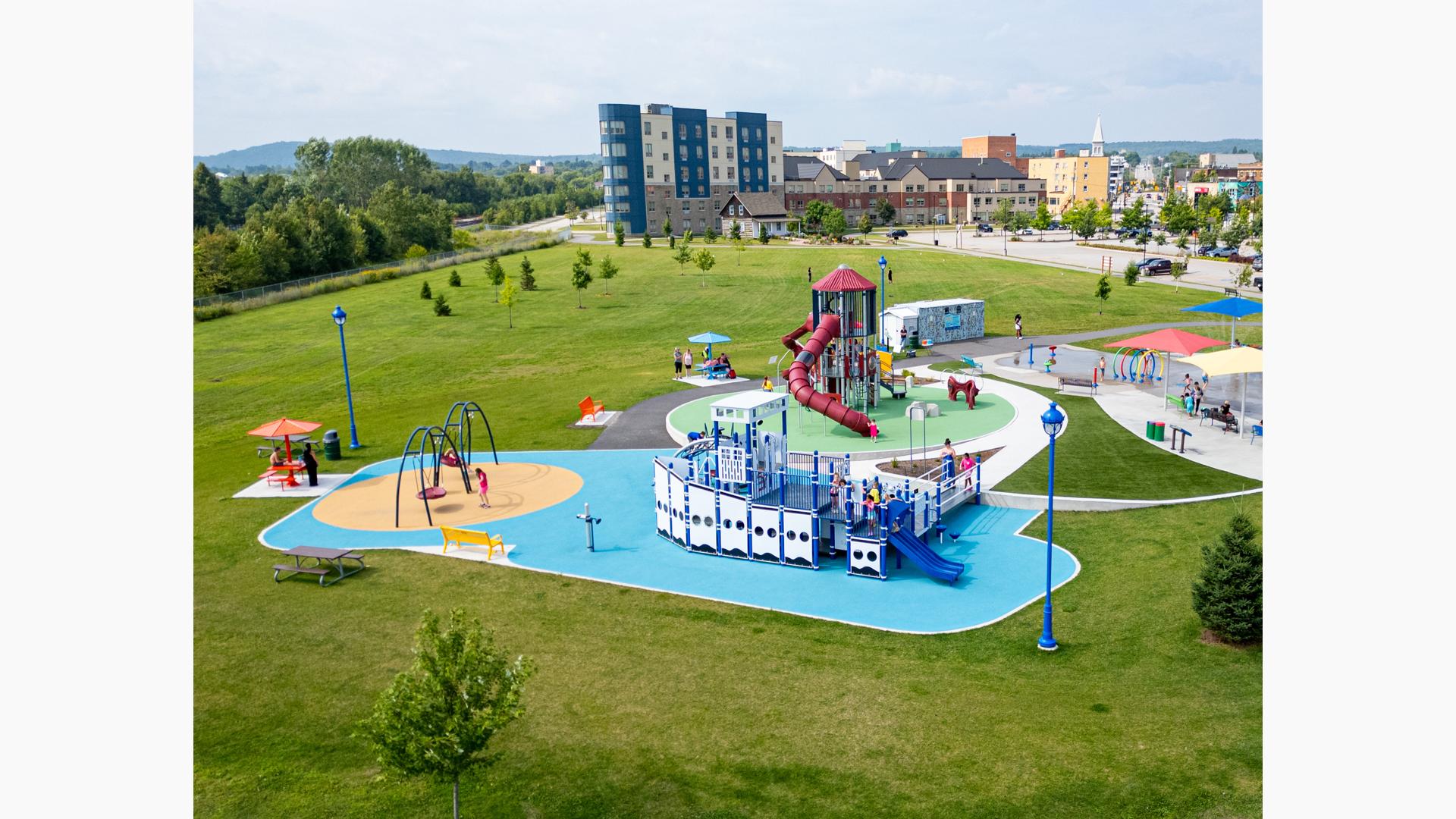 Elevated view of a park playground with a main play structure designed like a boat.