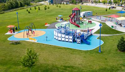 Elevated view of a park playground with a main play structure designed like a boat.