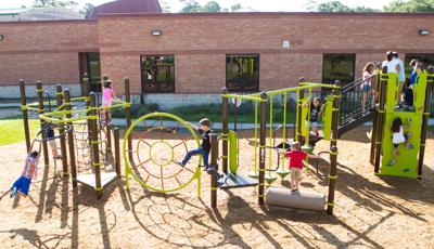 Oak Forest Elementary School, Houston, TX. This playground design features a Swing Out™, Spider Web Climber, Log Roll, and a PlayBooster® playstructure.