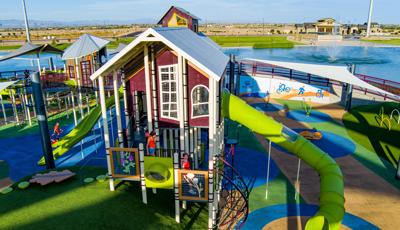 Elevated view of a tower house designed structure with a large green slide coming off the right hand side.