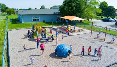 Elevated view of children playing on playground equipment at a learning center
