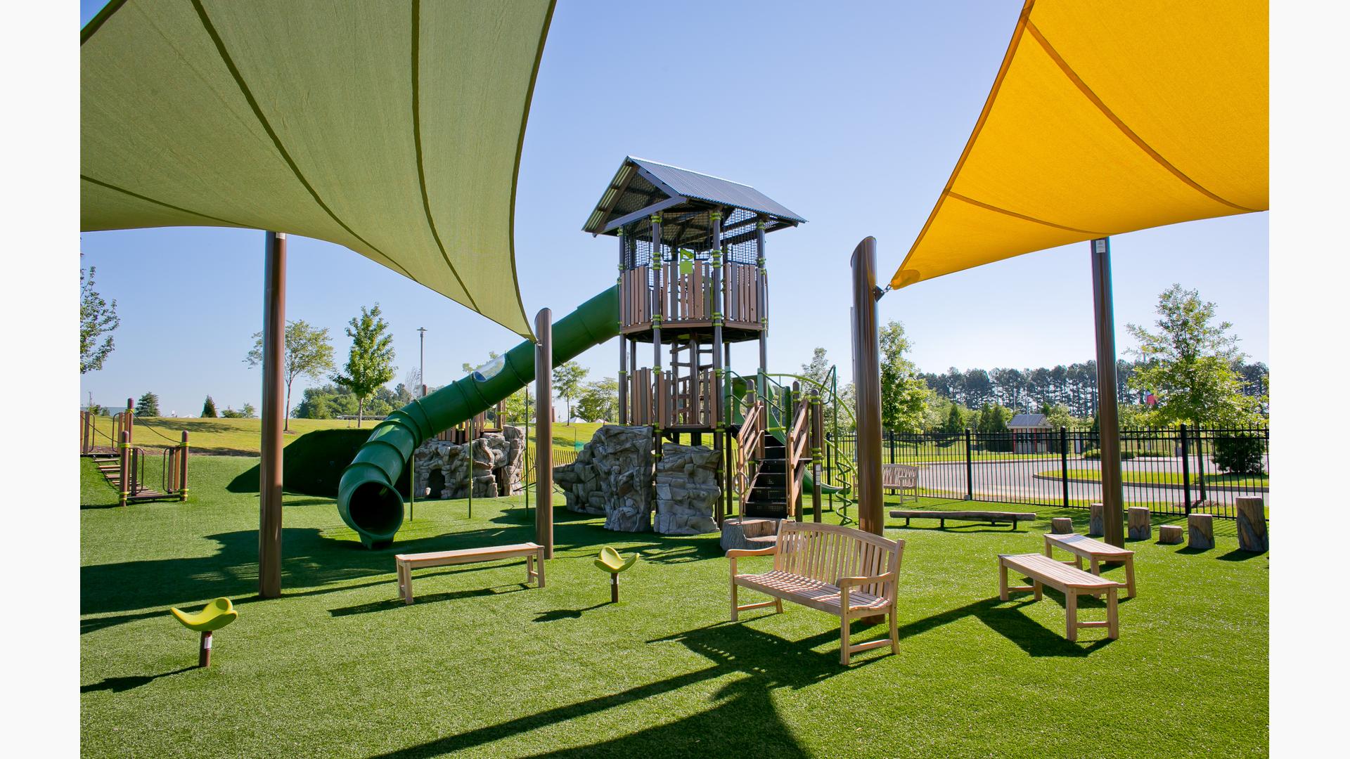 The PlayOdyssey® Tower at Discovery Park of America for age 5 to 12. Playground features a double bay ZipKrooz®, Rhapsody® Outdoor Musical Instruments, and SkyWays® shade.