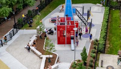 Aerial of children playing on PlayShaper slide and custom play structures