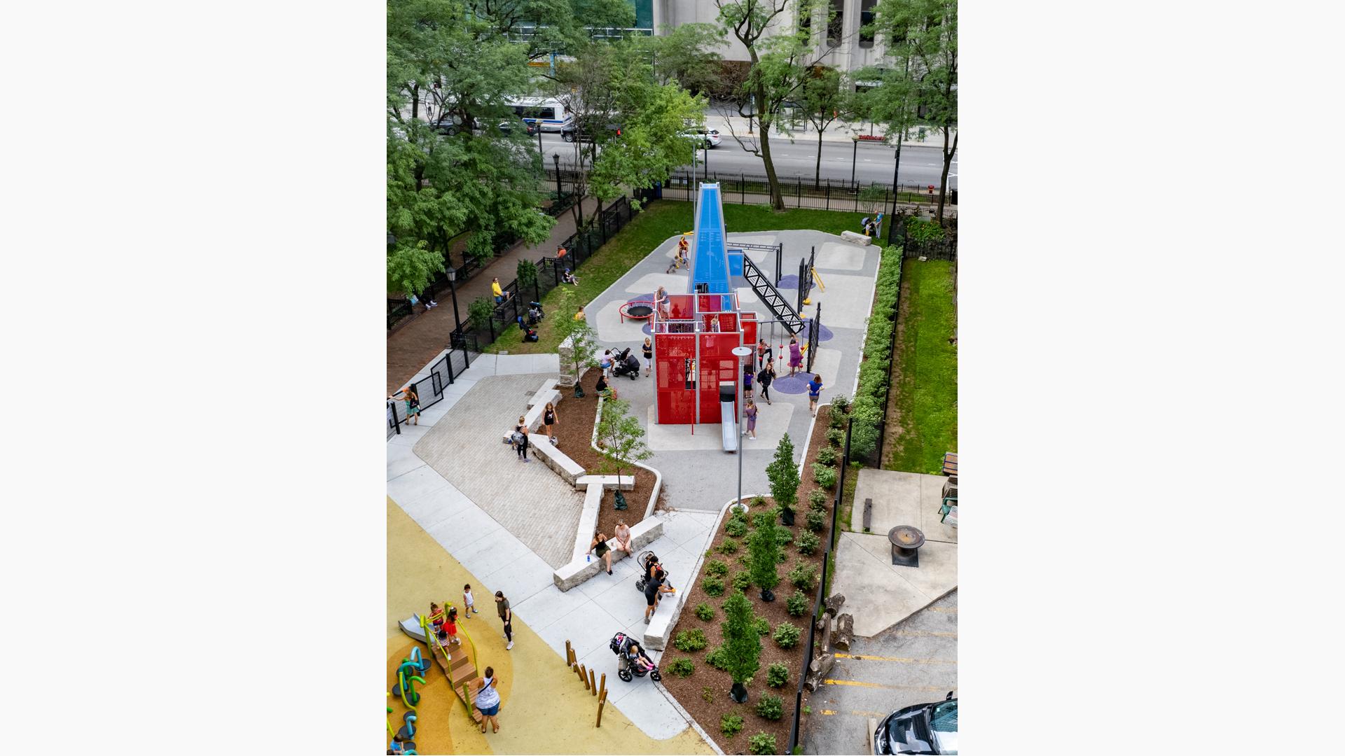 Aerial of children playing on PlayShaper slide and custom play structures