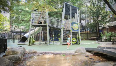 Girl runs across Joseph C. Sauer Park playscape