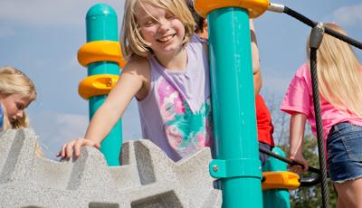 GIrl laughing on top of Geoplex climber