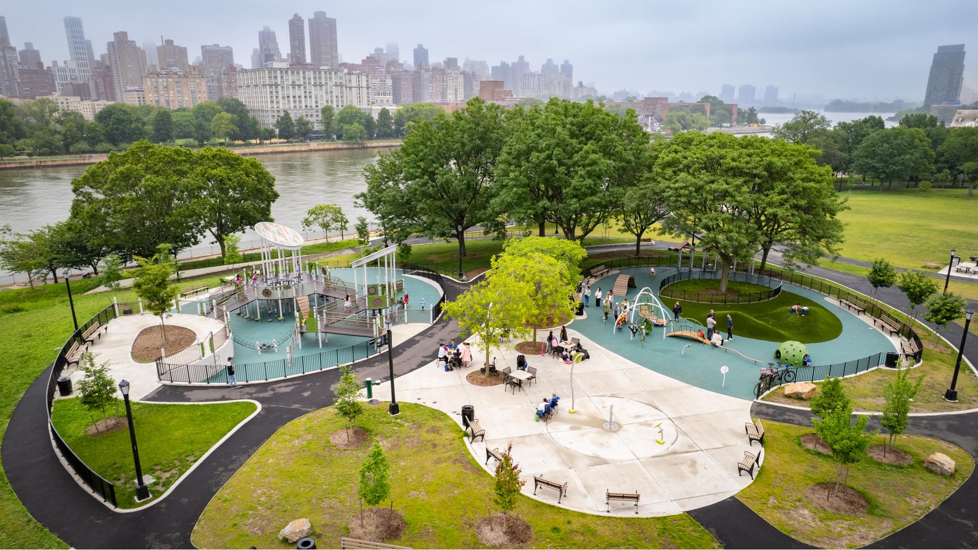 Elevated view of a city park with playground next to a waterfront.