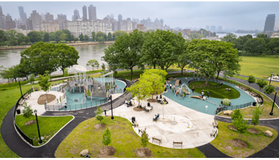 Elevated view of a city park with playground next to a waterfront.
