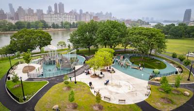 Elevated view of a city park with playground next to a waterfront.