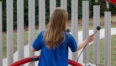 Girl playing on Rhapsody® Grandioso® Chimes