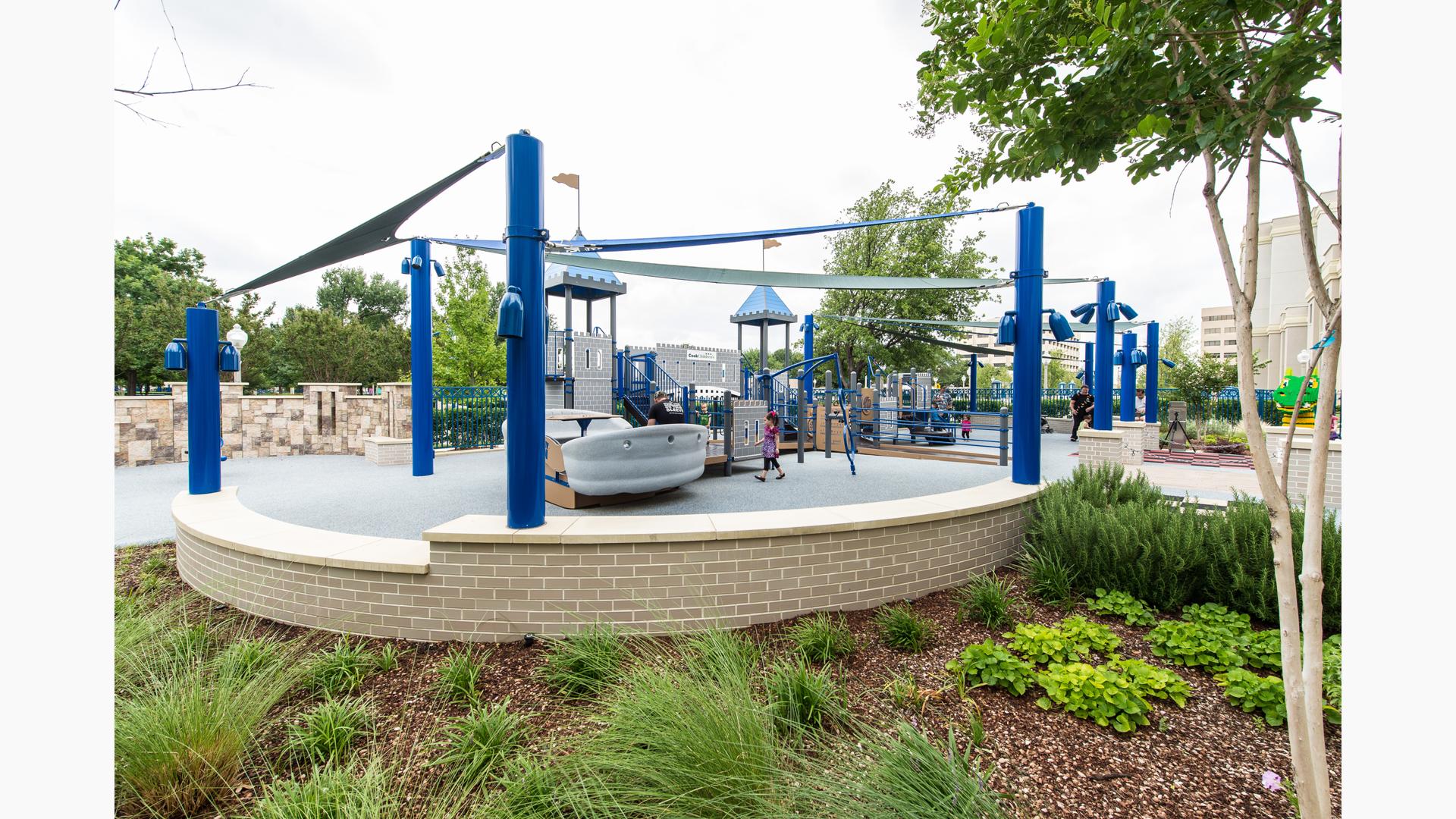 Cook Children’s Hospital, Fort Worth, Texas, for ages 5 to 12.  Custom medieval-theme PlayBooster® playstructure with access to ramps. Features inclusive play activities like sensory-stimulating play panels and Rollerslide, Sway Fun® Glider, and Talk Tubes.