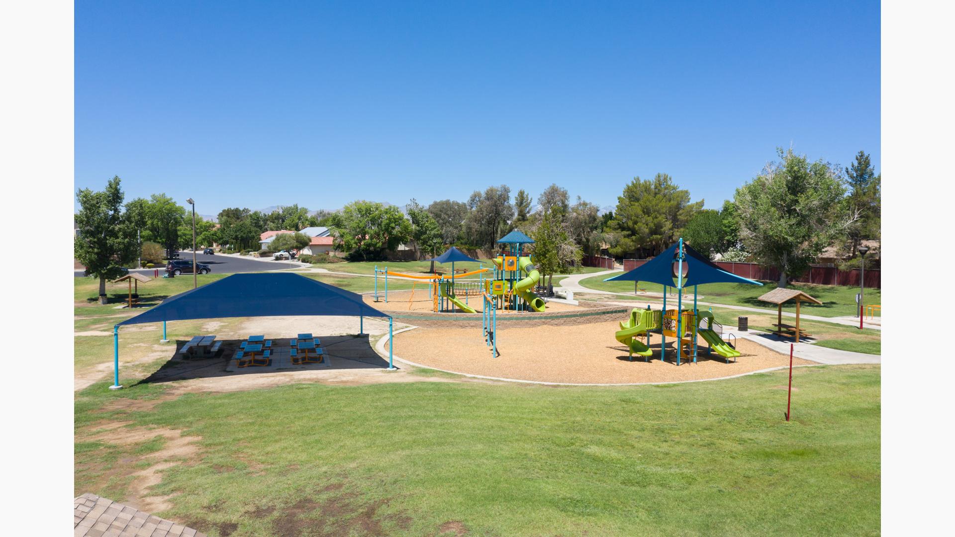 Nestled in a quaint neighborhood in Ridgecrest, CA, Pearson Park comes with two main structures for kids to play on. Along with swings and a Zipline, as well as picnic tables covered in SkyWays shade.