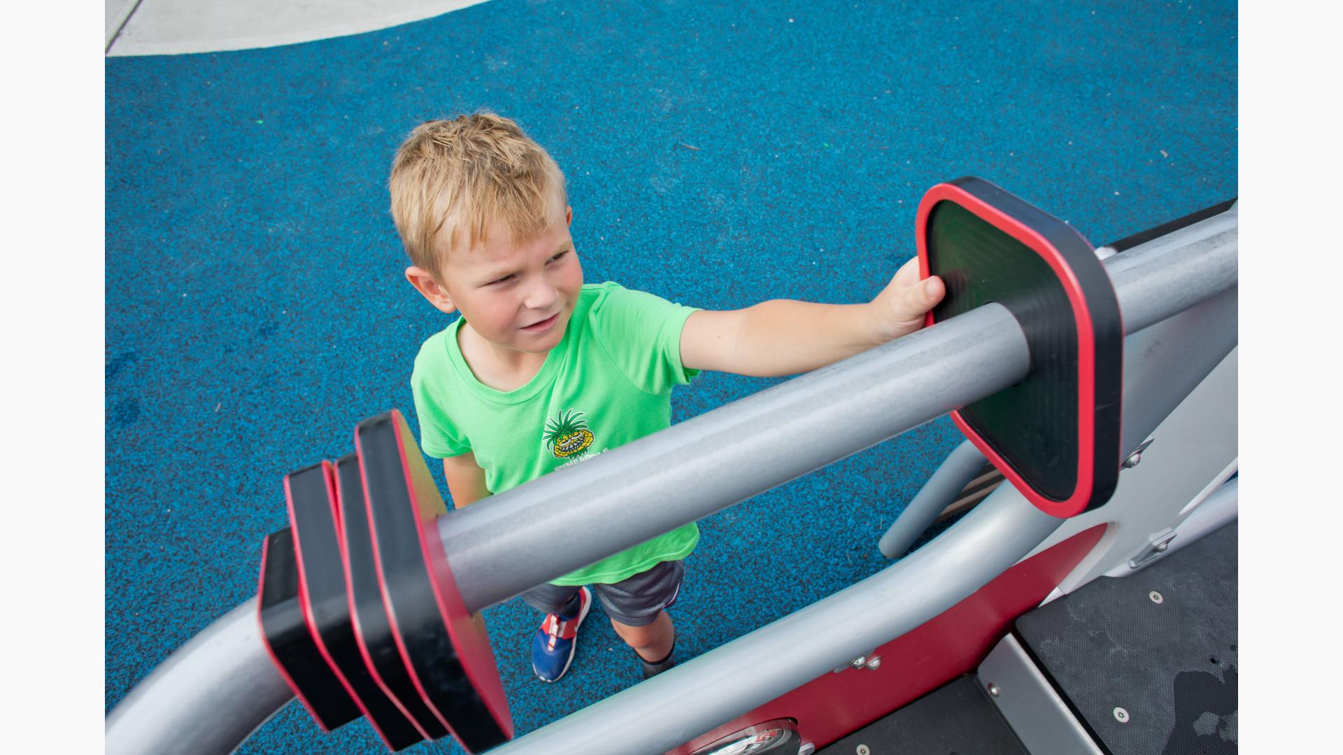 Boy playing with slider on playscape