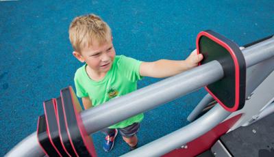 Boy playing with slider on playscape