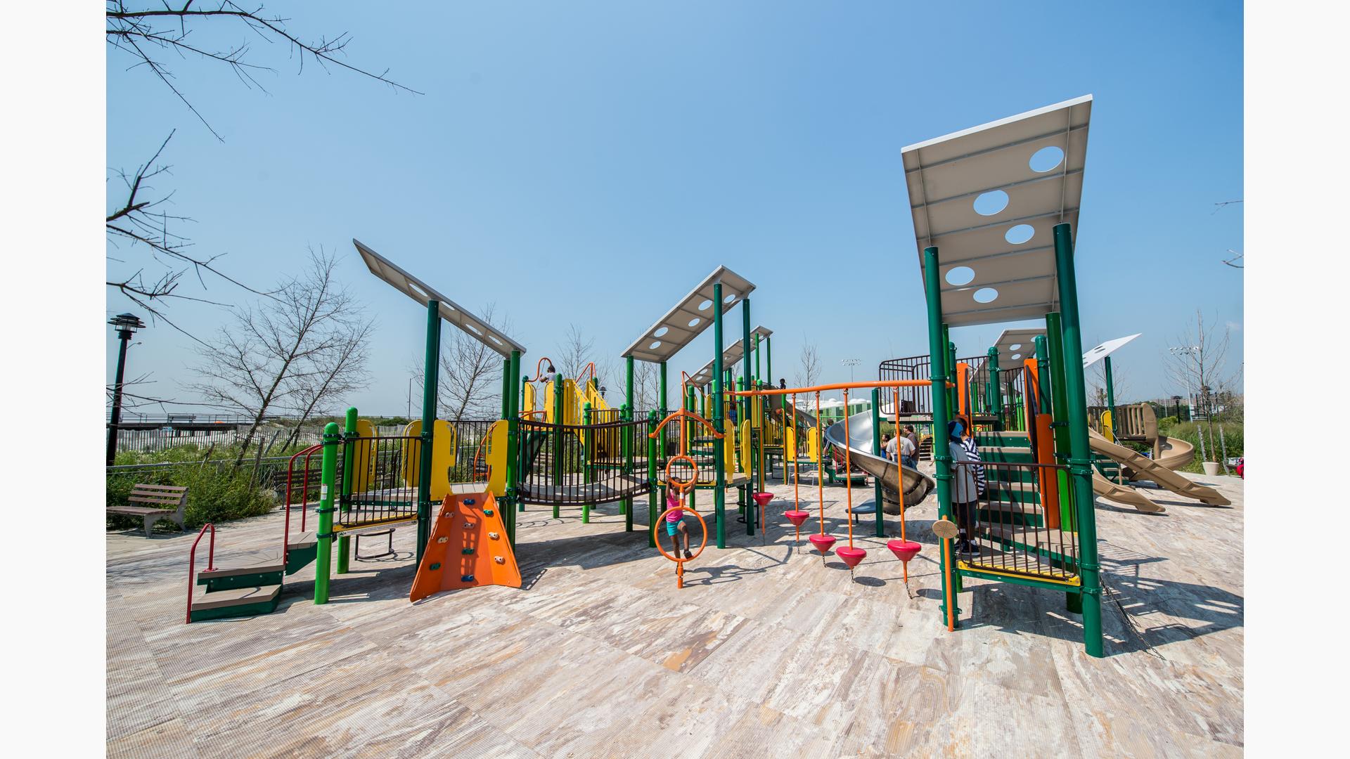 Girl climbing spinner in center of playground