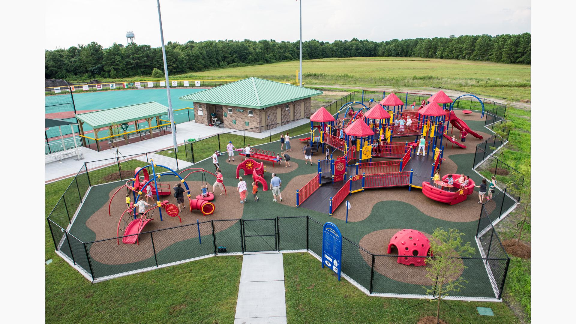 Olsen Park Wilmington, NC features an inclusive playground including a PlayBooster® play structure, accessible ramps, sensory-rich play panels, and many playground climbers and slides. Plus, a Weevos® play structure.