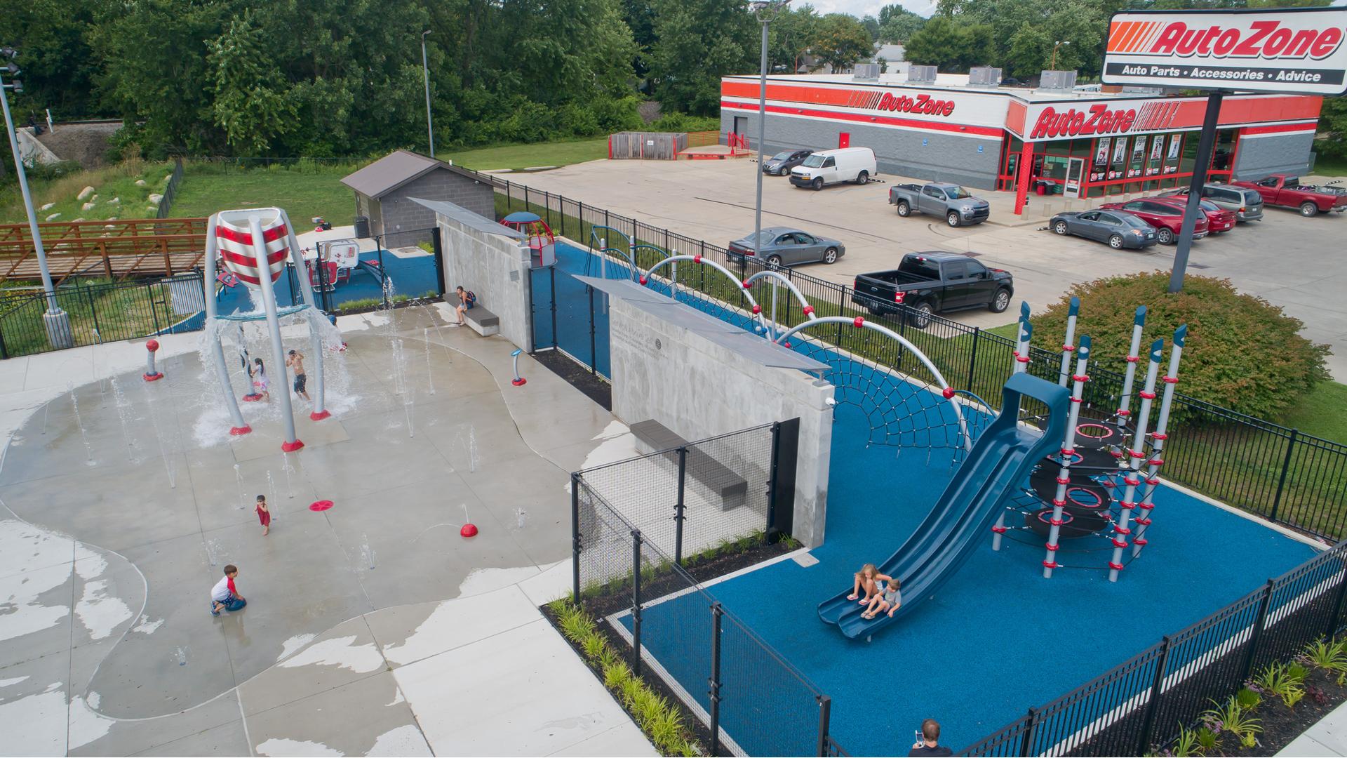 Prairie Creek park - aerial of children playing on playscape and splash pad