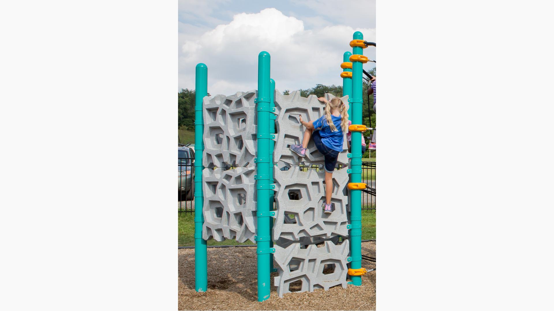 Girl on Geoplex climbing wall