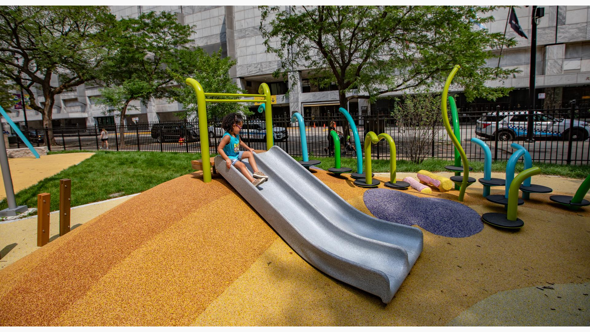 Girl sitting at top of PlayShaper slide