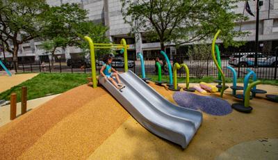 Girl sitting at top of PlayShaper slide