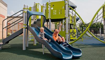 Two boys riding Double Wave slide