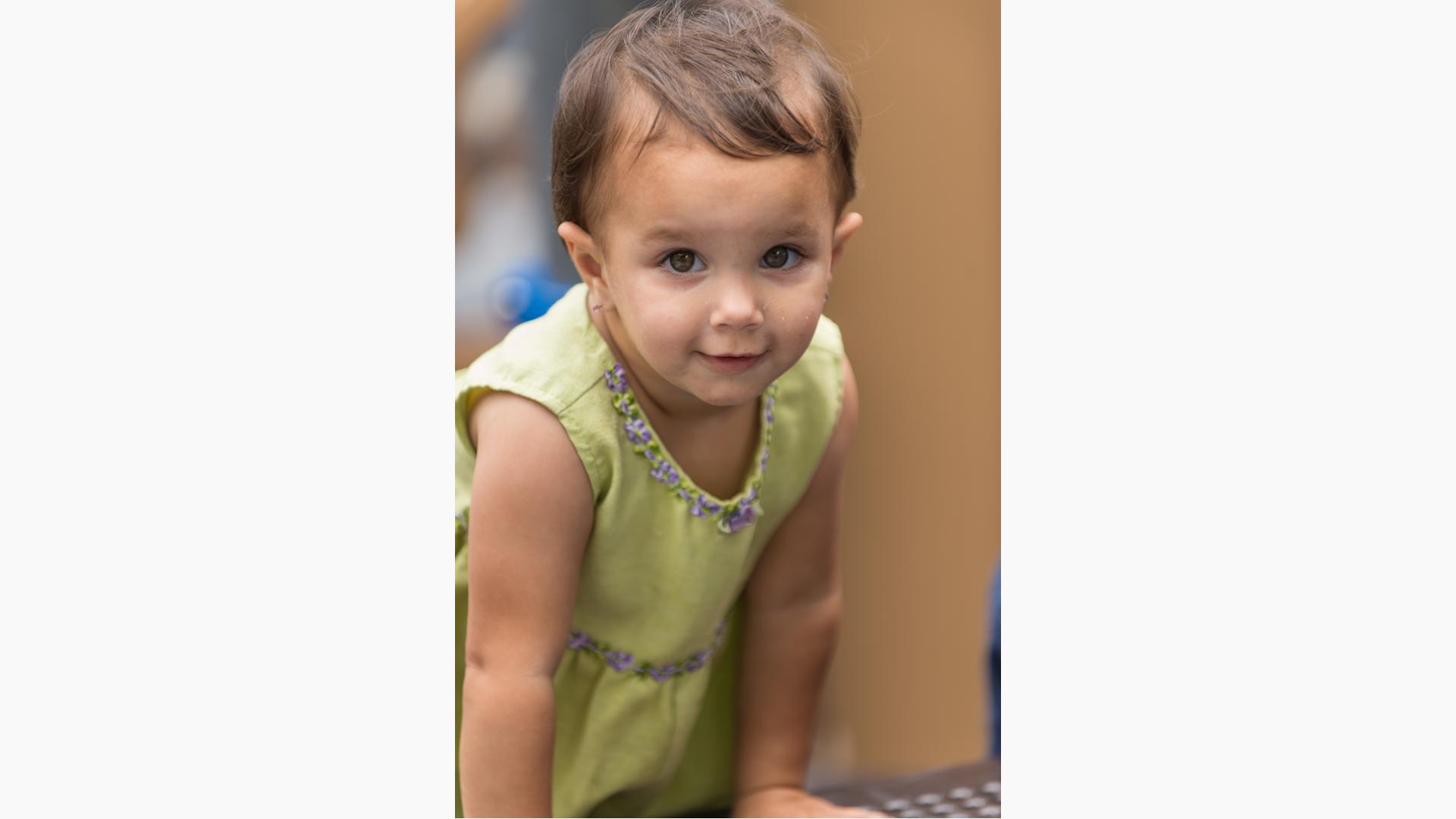 Little girl in yellow dress smiling