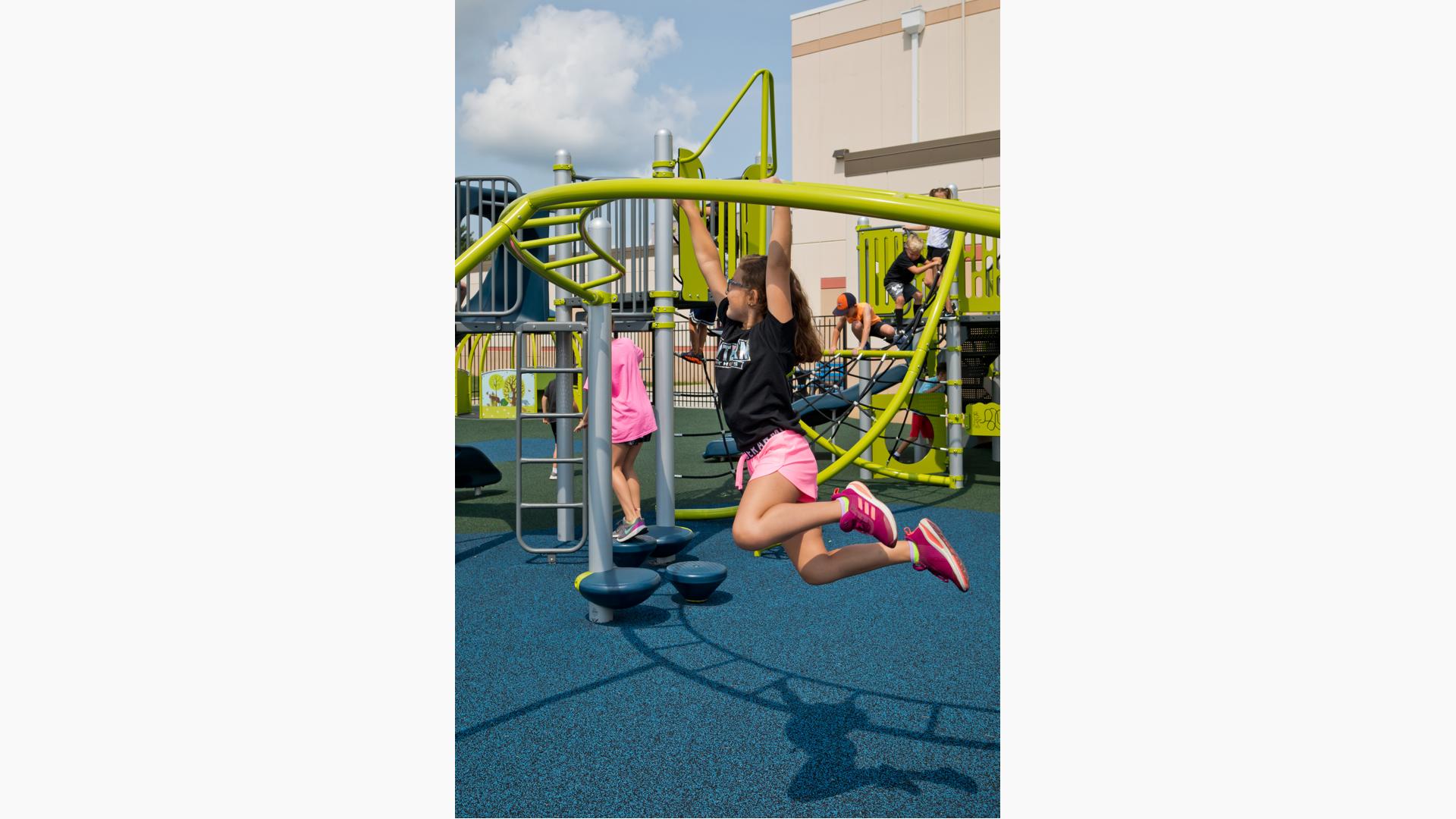 Girl swings on Overhead Trekker™ Ladder