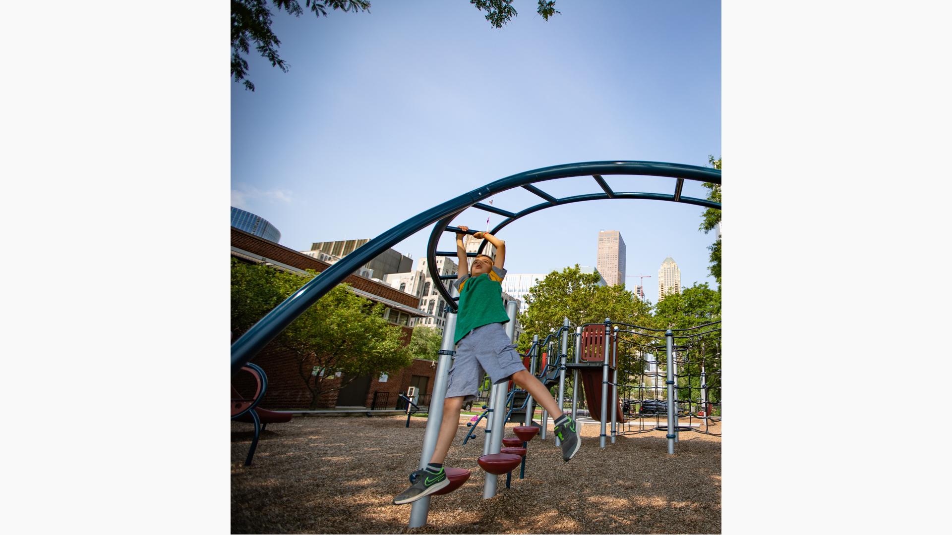 Boy crossing overhead event (monkey bars)