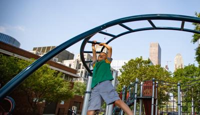 Boy crossing overhead event (monkey bars)