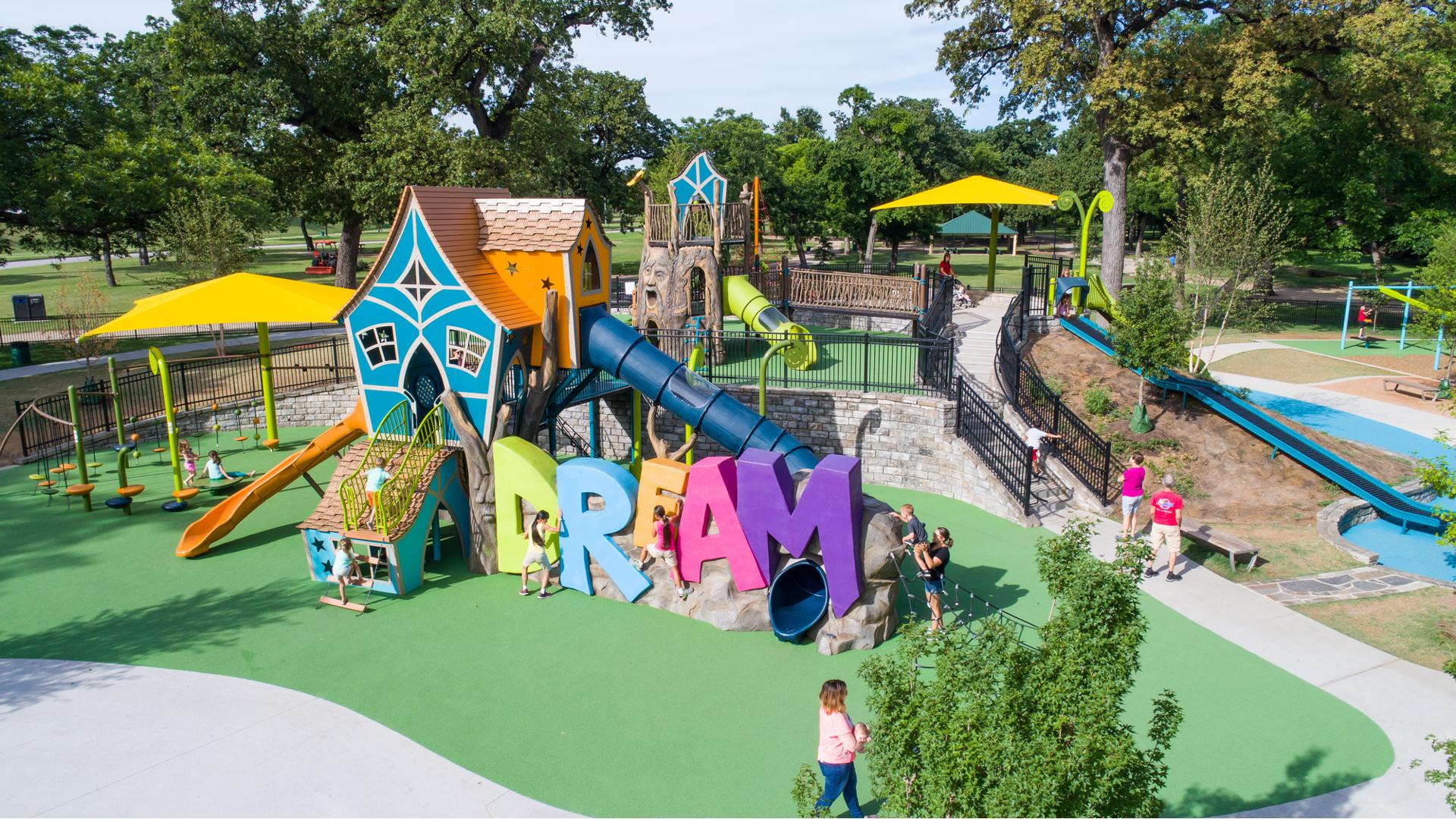 Sprawling inclusive playground; Frank Kent's Dream Park in Fort Worth, TX offers an  inclusive playground with a concrete-sculpted DREAM climber centerpiece. A hot air balloon-themed play space for ages 2 to 5. As well as a Double ZipKrooz®, We-saw™, playground swings, and net climbers.