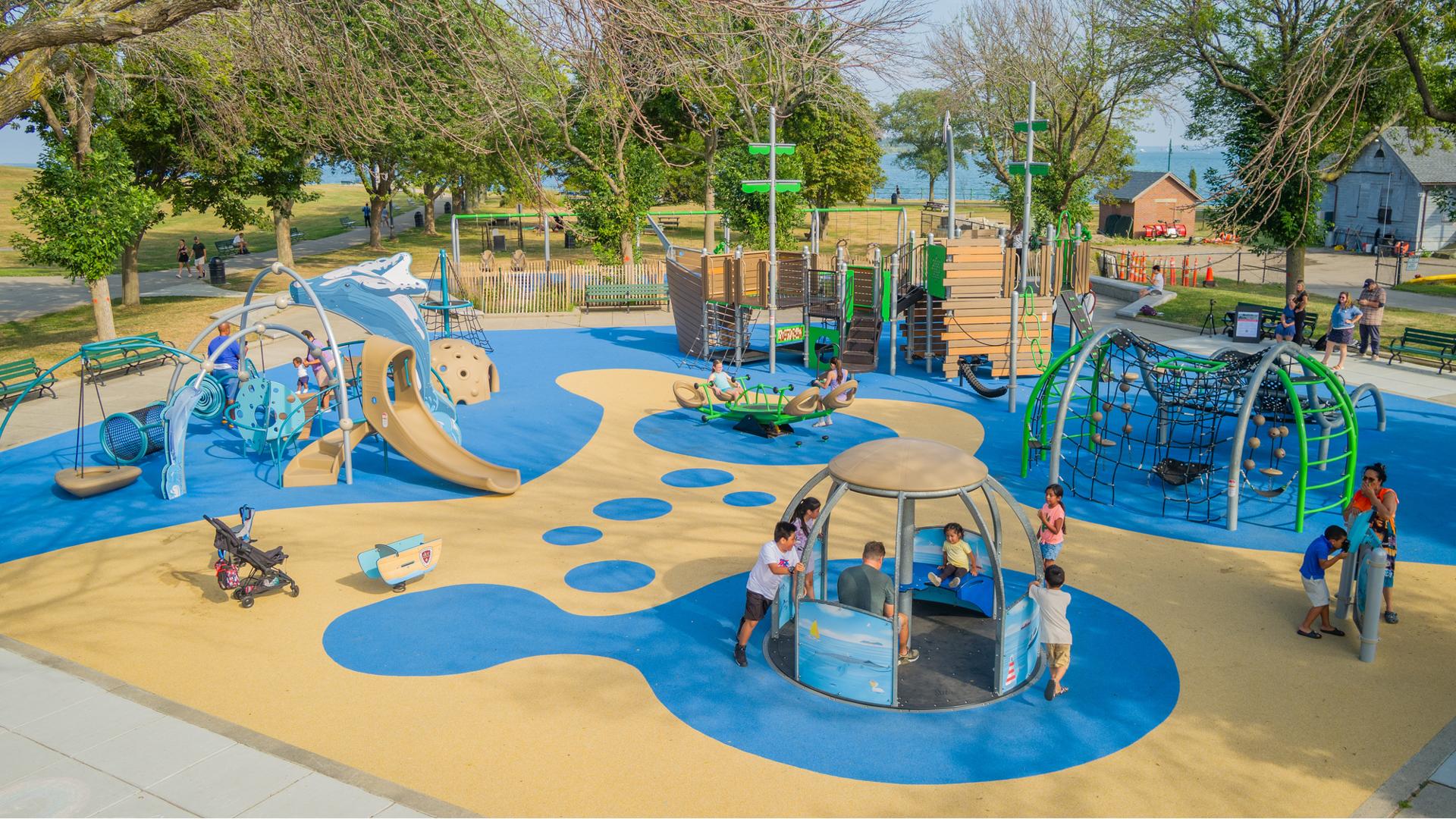 Elevated view of children playing on a boat and ocean themed playground.