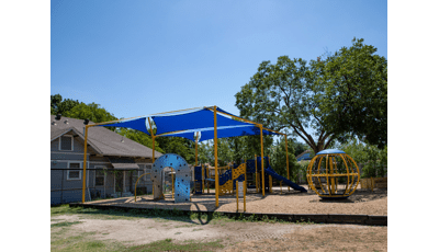 Two shade strutures cover this PlayBooster structure next to a Global spinner.