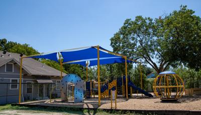 Two shade strutures cover this PlayBooster structure next to a Global spinner.