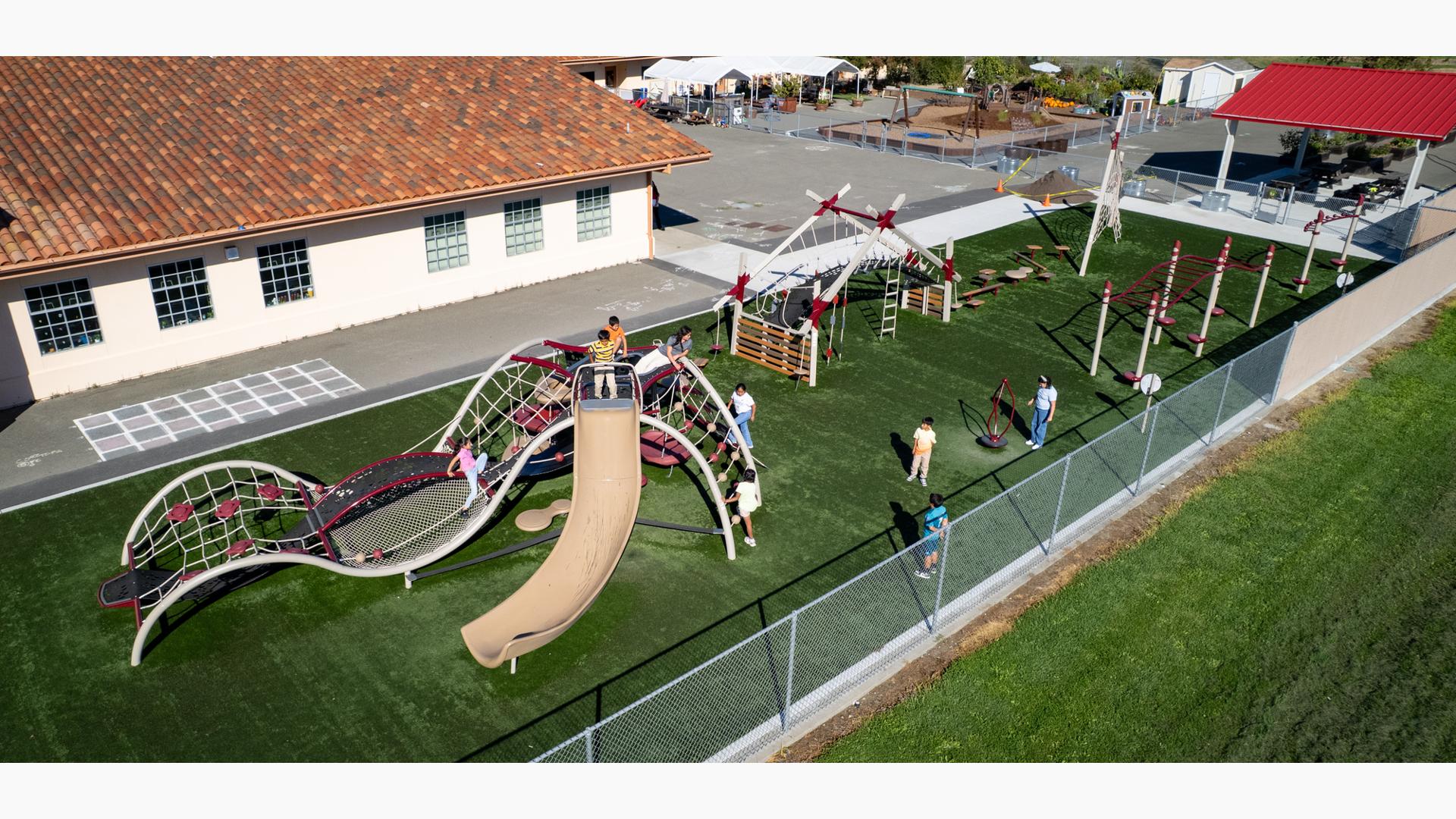 Elevated view of a school playground filled with playing children.