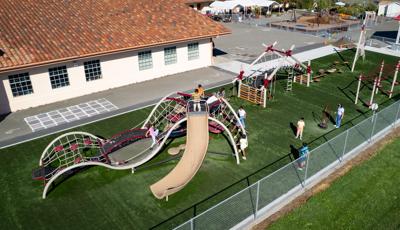 Elevated view of a school playground filled with playing children.