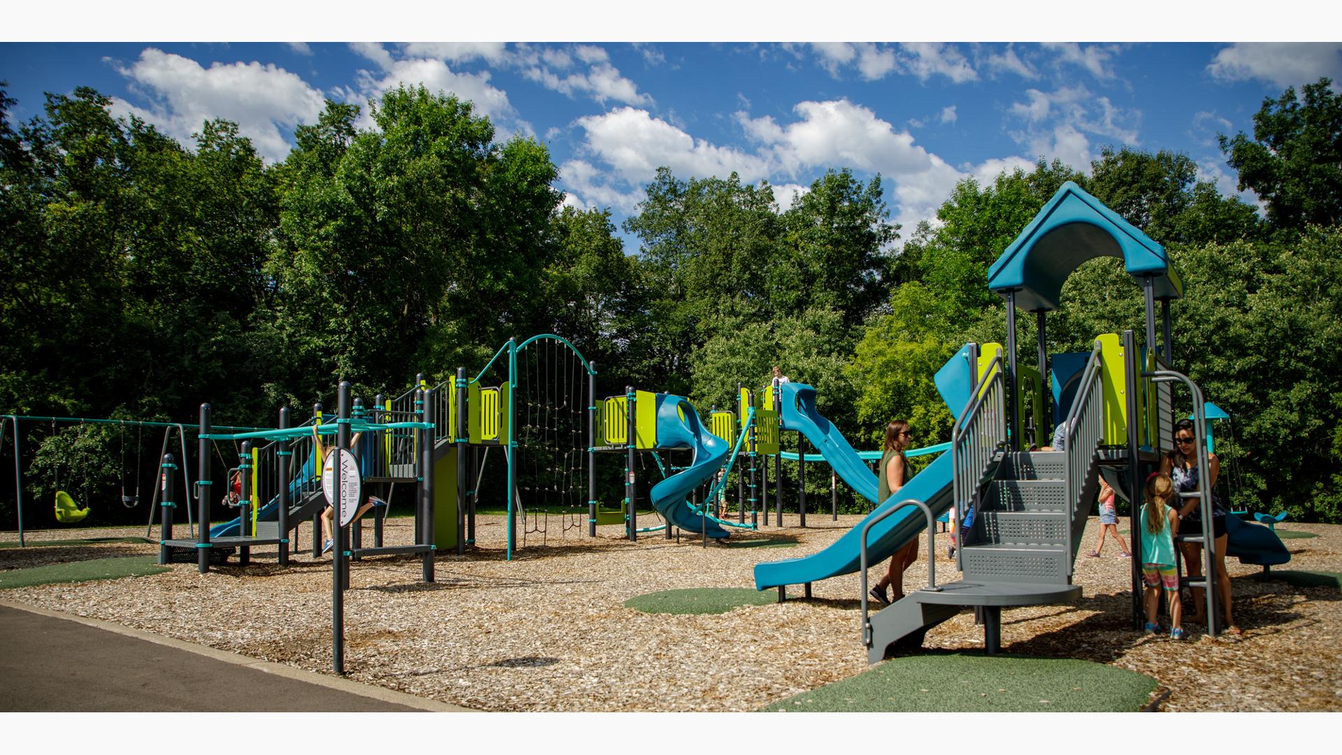 Kids playing on play structures at Basswood Park Maple Grove, MN