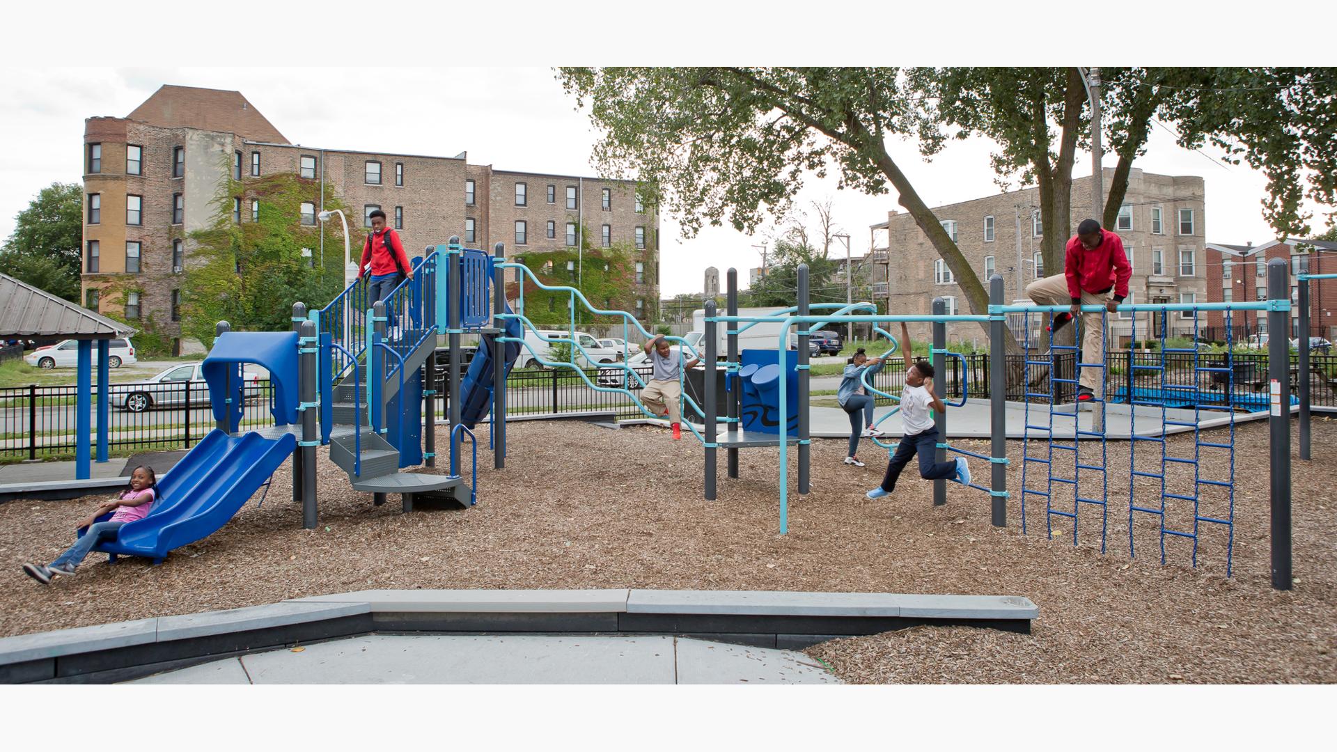 Children play on all the many playground activities at a community park.