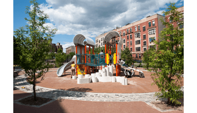 Woman watches boys climbing on play structure.