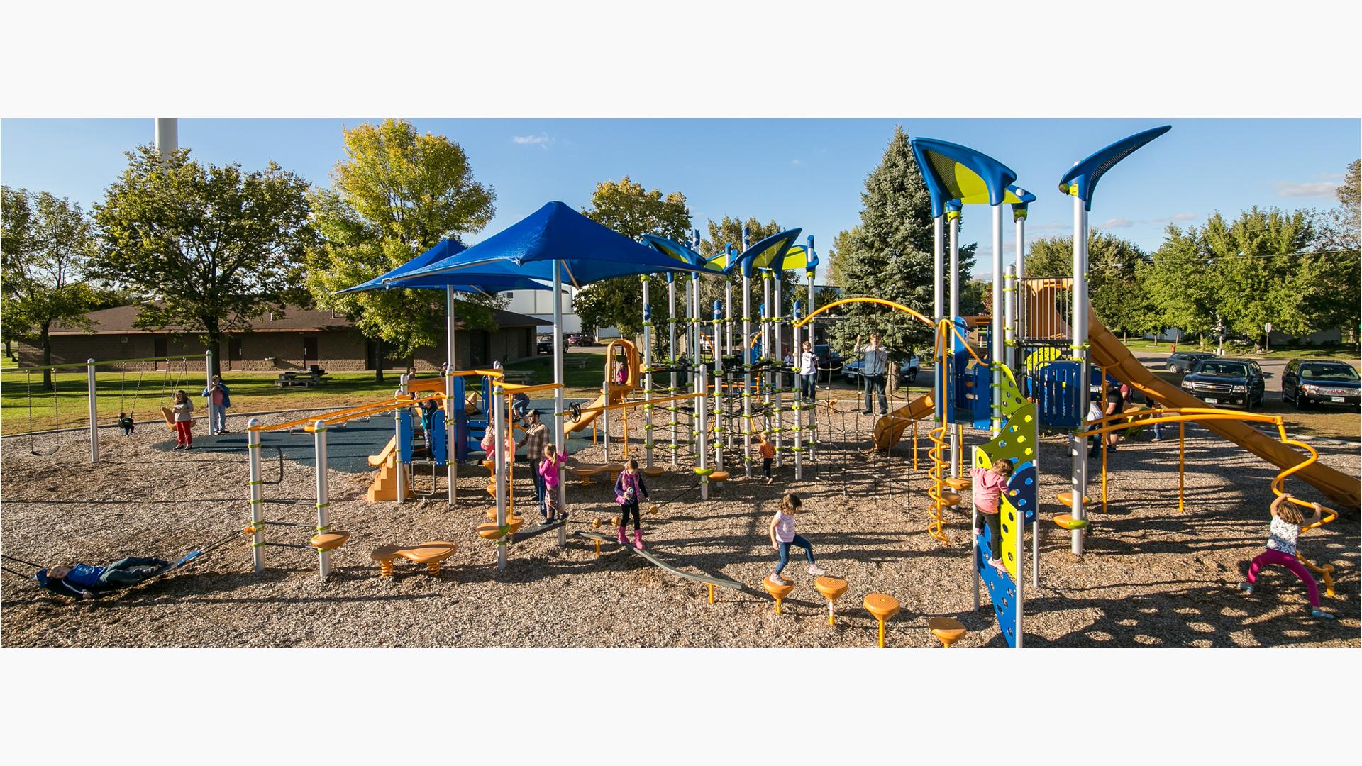 Lions Park Clearwater, MN. The main Netplex® play structure is anchored by a Skyport™ Climber, which features vertical net tunnels and latex-free rubber landings. Platground also features the Crest Climber, the S-Disc Challenge or spin around and around on the Blender™ Spinner.