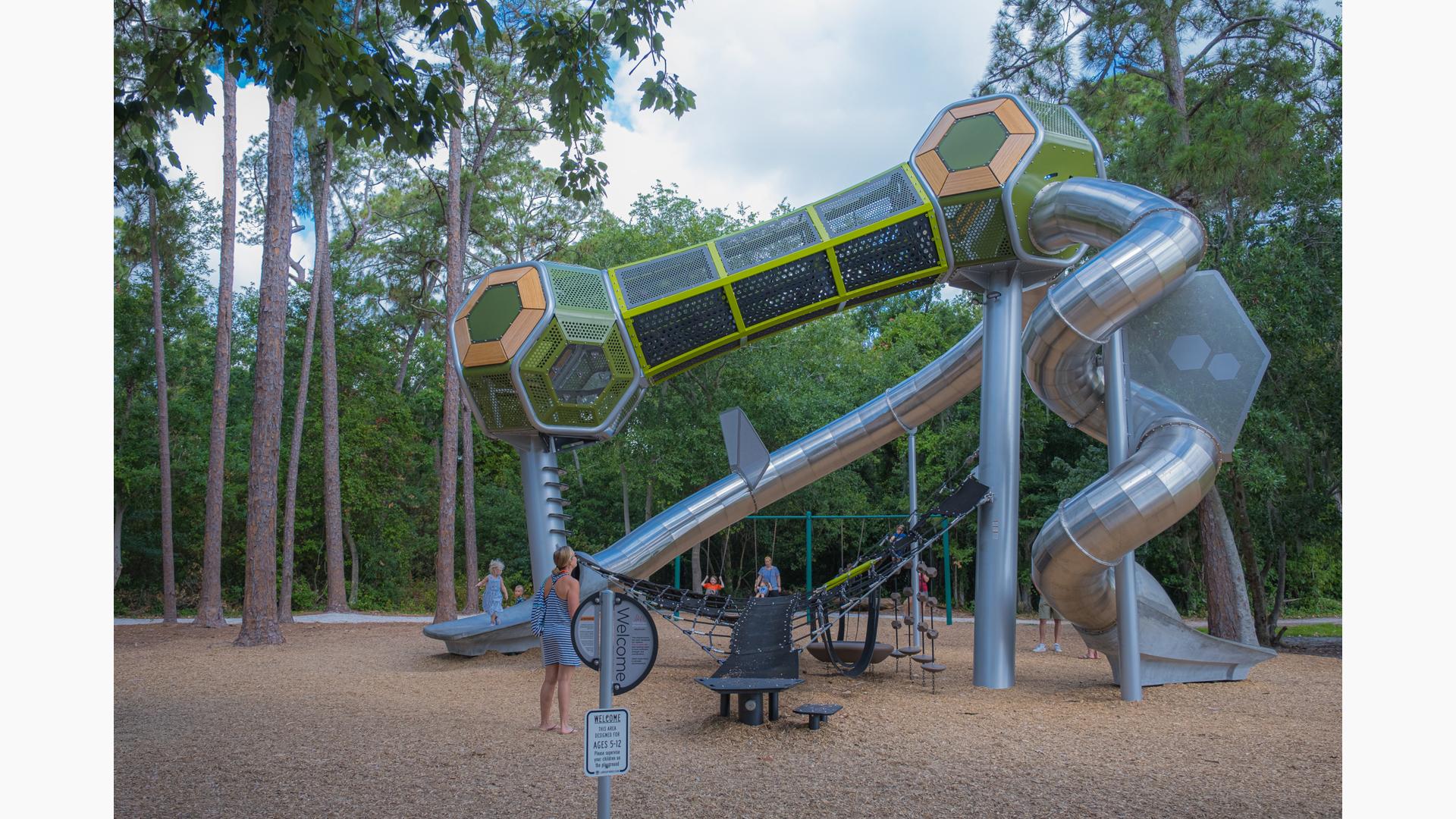 Families playing on Hedra playground at Highland Recreation Complex in Largo, FL