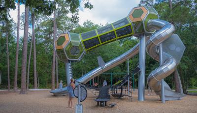 Families playing on Hedra playground at Highland Recreation Complex in Largo, FL