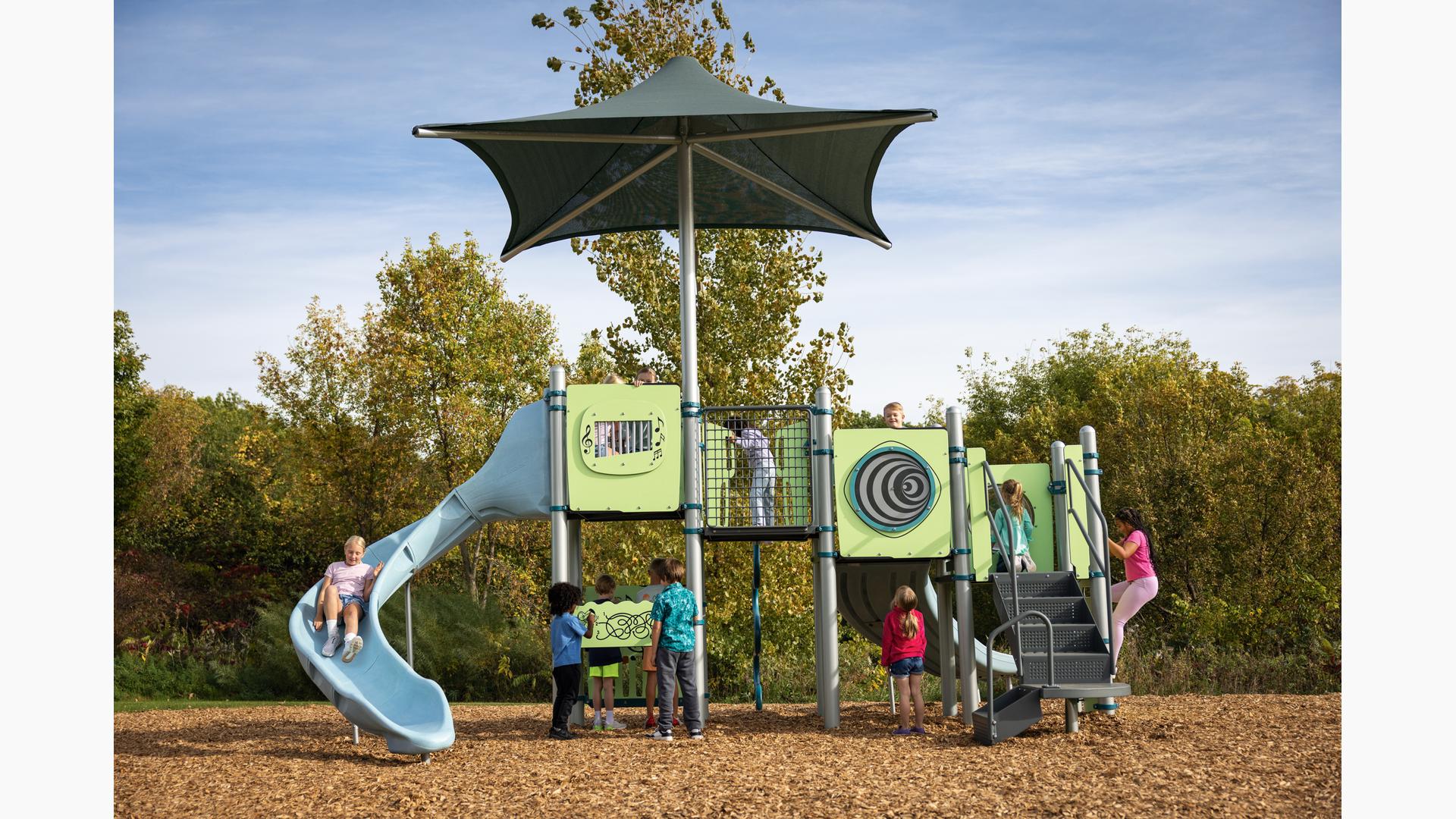 Children playing on a playground structure with fun interactive panels.