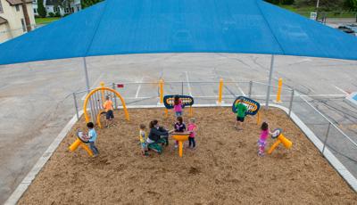 Freestanding Rhapsody Outdoor Musical Instruments for Ages 2 to 5 under SkyWays shade canopy.
